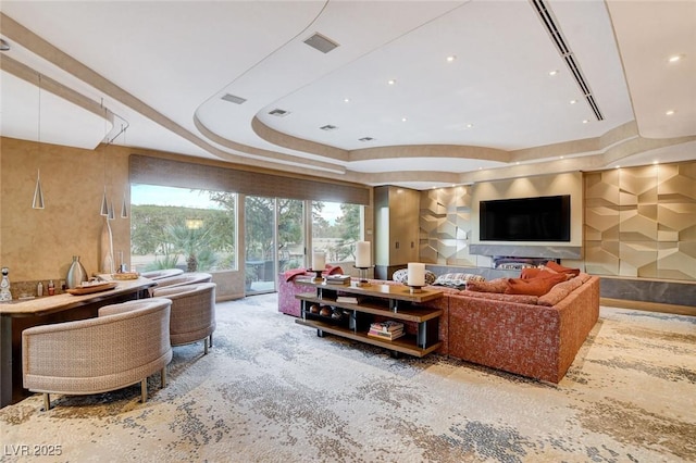 living room featuring visible vents and a tray ceiling