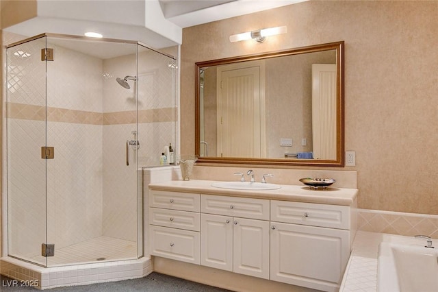 full bathroom featuring vanity, a shower stall, and a washtub