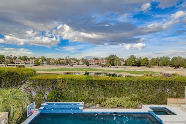 view of pool featuring a pool with connected hot tub and a water view