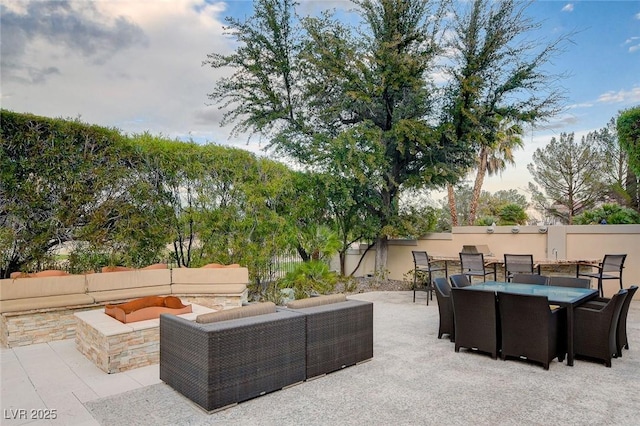 view of patio / terrace featuring an outdoor living space, a fenced backyard, and outdoor dining space