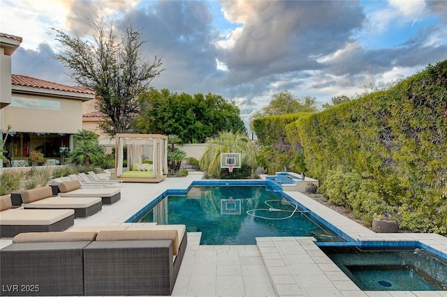 pool with a patio and an in ground hot tub