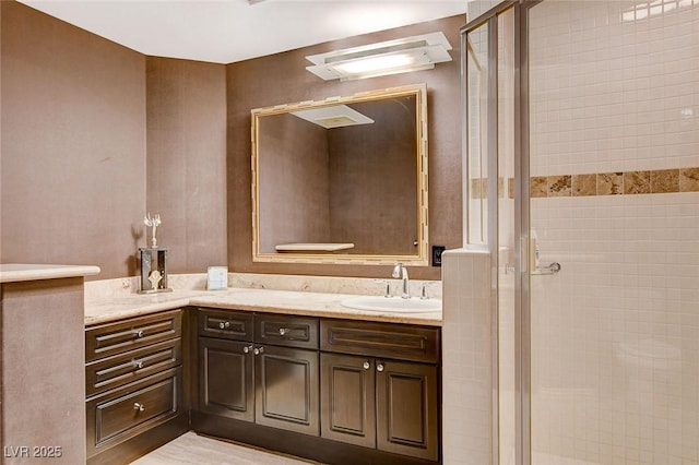 full bath featuring vanity and a shower stall