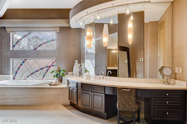 bathroom with vanity and a garden tub