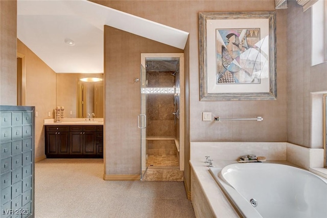 bathroom featuring vanity, a tub with jets, and a stall shower