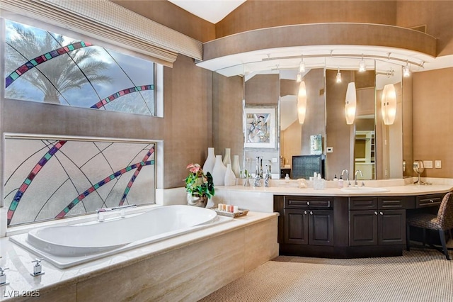 bathroom with a garden tub and vanity