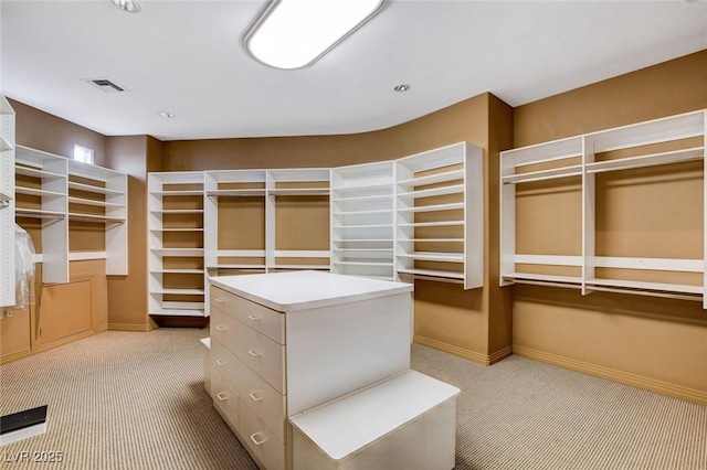 walk in closet featuring light carpet and visible vents