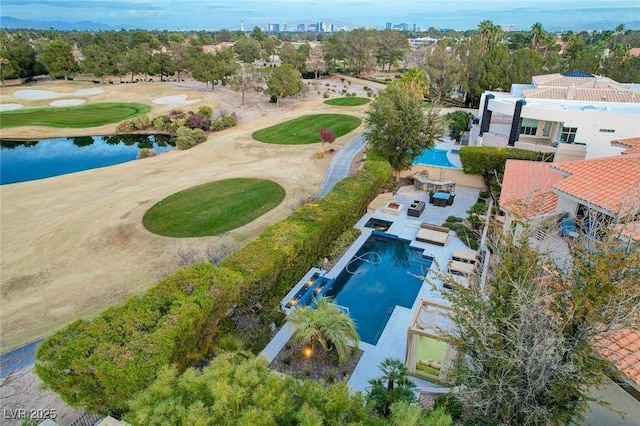 birds eye view of property with a water view and view of golf course