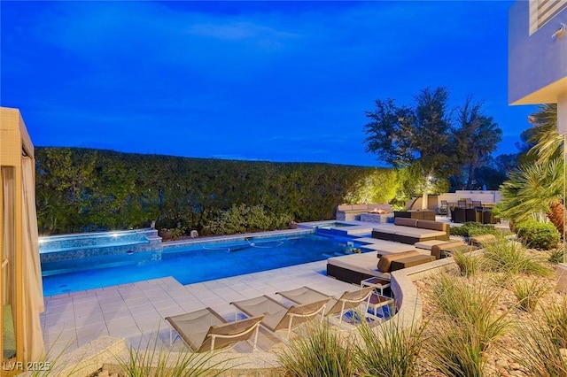 view of pool featuring a patio and a pool with connected hot tub