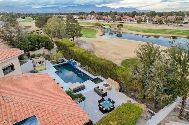 birds eye view of property featuring view of golf course and a water and mountain view