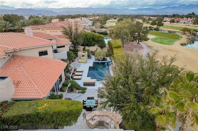 birds eye view of property with a water and mountain view