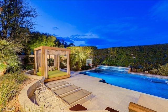 view of swimming pool featuring a pool with connected hot tub and a patio