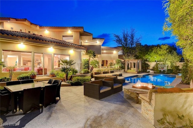 pool at twilight featuring an outdoor pool, outdoor dining area, an outdoor living space, and a patio area