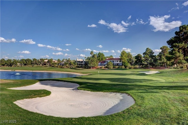 view of home's community featuring a yard, a water view, and golf course view