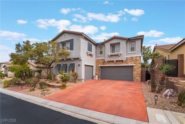 mediterranean / spanish-style house featuring driveway, an attached garage, stucco siding, stone siding, and a tile roof