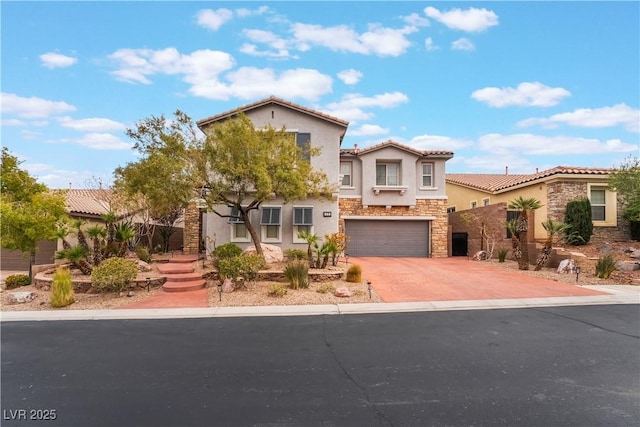 mediterranean / spanish-style home featuring concrete driveway, a tile roof, stucco siding, a garage, and stone siding