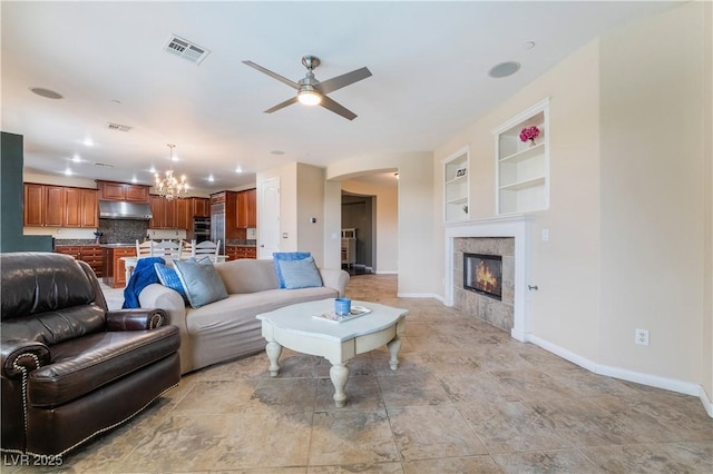872 Timber Walk Dr, Henderson, NV 89052 - living room featuring visible vents, baseboards, built in features, ceiling fan with notable chandelier, and arched walkways