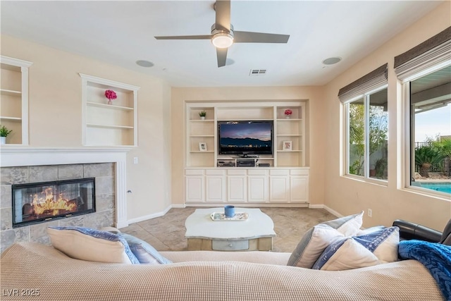 872 Timber Walk Dr, Henderson, NV 89052 - living area with visible vents, built in features, a fireplace, baseboards, and ceiling fan