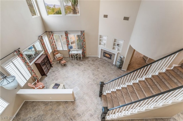 872 Timber Walk Dr, Henderson, NV 89052 - interior space with a glass covered fireplace, visible vents, and a towering ceiling