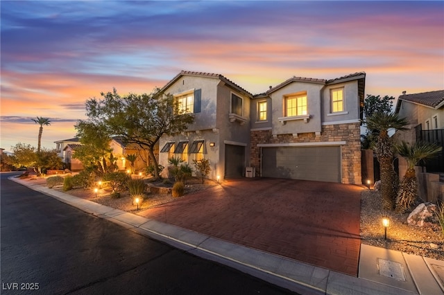 872 Timber Walk Dr, Henderson, NV 89052 - mediterranean / spanish-style home with a tile roof, stucco siding, decorative driveway, stone siding, and an attached garage