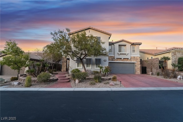 872 Timber Walk Dr, Henderson, NV 89052 - view of front of house with a tiled roof, stucco siding, driveway, stone siding, and an attached garage