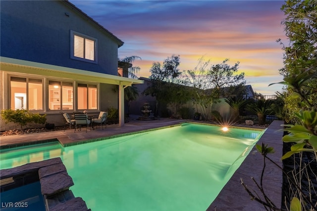872 Timber Walk Dr, Henderson, NV 89052 - pool at dusk with a fenced in pool, a patio area, and fence
