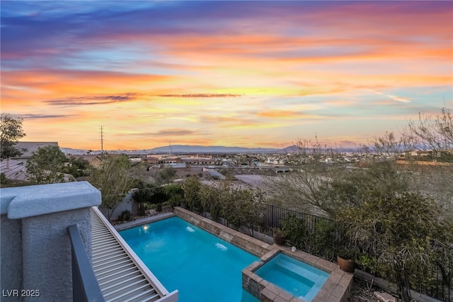 872 Timber Walk Dr, Henderson, NV 89052 - pool at dusk featuring a mountain view and a pool with connected hot tub