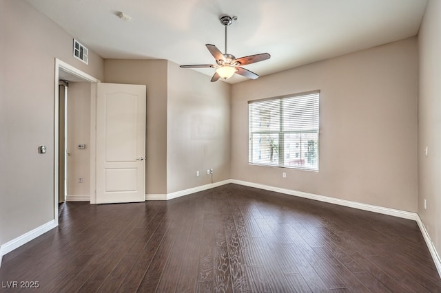 unfurnished room featuring dark wood-style floors, baseboards, and ceiling fan