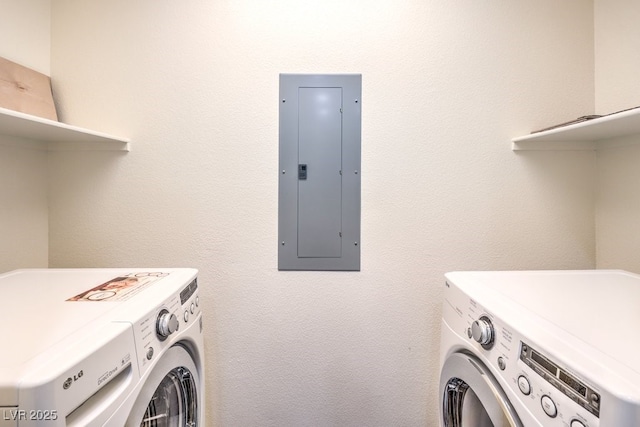 clothes washing area with electric panel, laundry area, and washer and clothes dryer