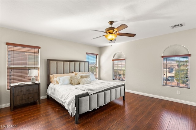 bedroom featuring visible vents, baseboards, and hardwood / wood-style floors