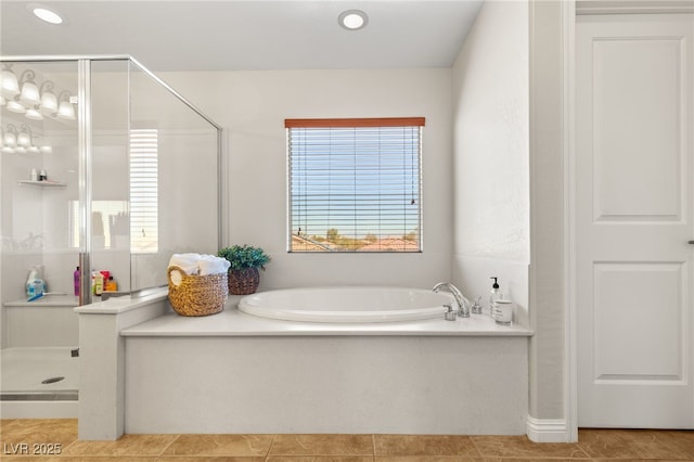 full bath with tile patterned flooring, a shower stall, and a garden tub