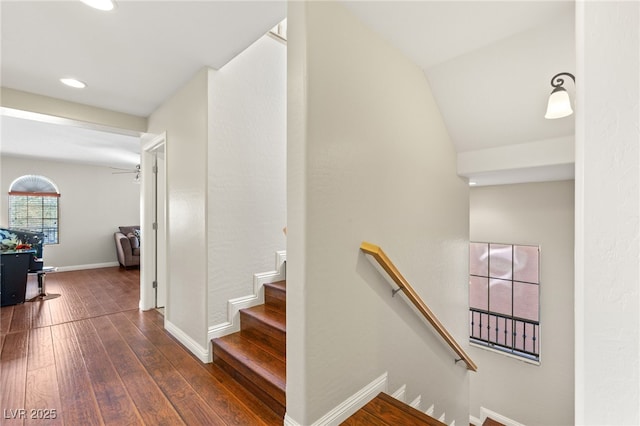 stairs with lofted ceiling, baseboards, and wood-type flooring