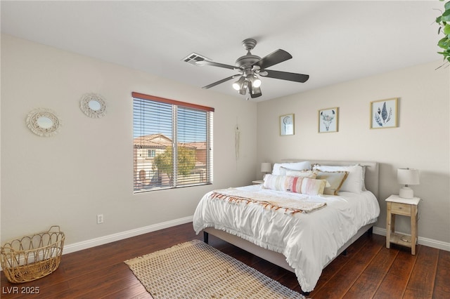 bedroom with hardwood / wood-style floors, baseboards, visible vents, and a ceiling fan