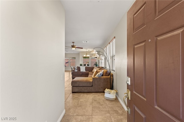 entrance foyer with light tile patterned floors, visible vents, baseboards, and a ceiling fan