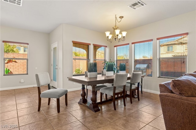 dining room with an inviting chandelier, baseboards, and visible vents