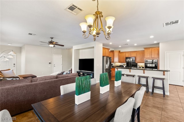 dining space with recessed lighting, visible vents, and ceiling fan with notable chandelier