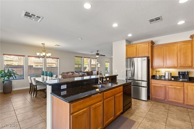 kitchen featuring dishwasher, stainless steel fridge with ice dispenser, visible vents, and a sink