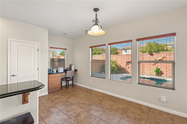 dining room with light tile patterned floors and baseboards