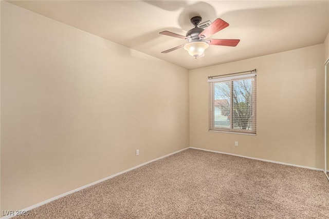 empty room featuring baseboards, ceiling fan, and carpet floors