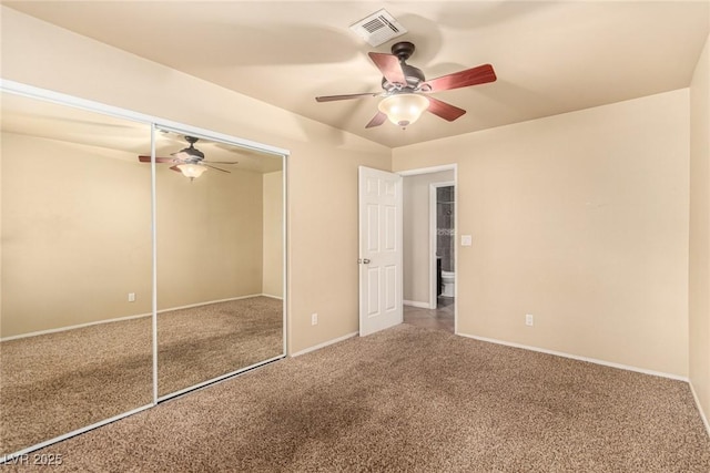 unfurnished bedroom featuring visible vents, baseboards, ceiling fan, carpet flooring, and a closet