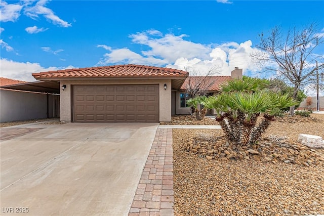 mediterranean / spanish-style house featuring stucco siding, a tiled roof, concrete driveway, and an attached garage