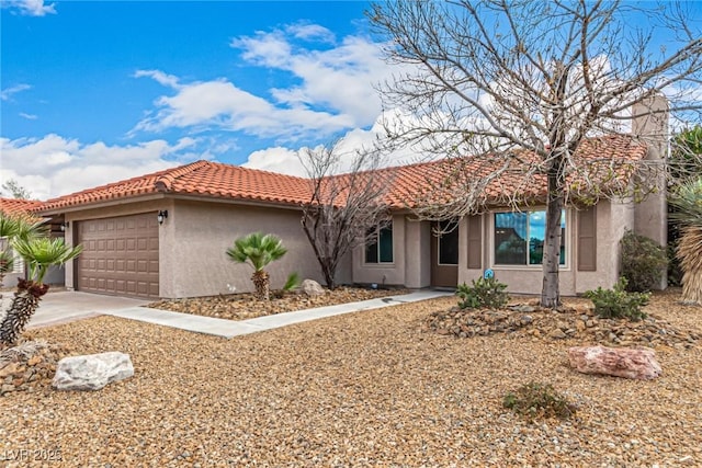 single story home featuring stucco siding, an attached garage, a tile roof, and driveway