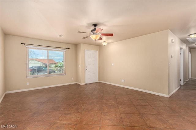 unfurnished room with tile patterned flooring, visible vents, baseboards, and ceiling fan