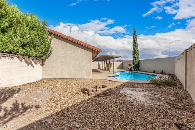 view of swimming pool with a patio, a fenced backyard, a fenced in pool, and a fire pit