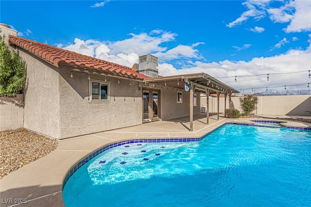 view of swimming pool featuring a patio, a fenced backyard, french doors, a fenced in pool, and an in ground hot tub