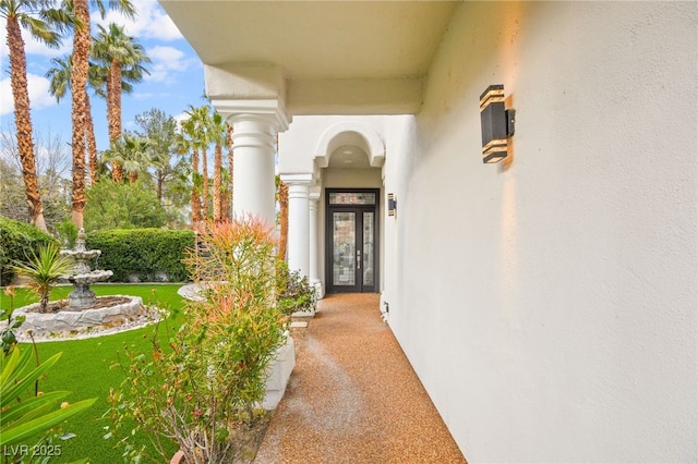 entrance to property featuring french doors and stucco siding