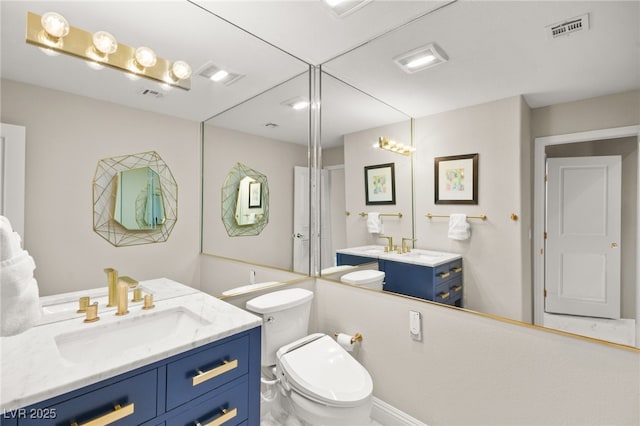 full bathroom featuring a sink, visible vents, and two vanities