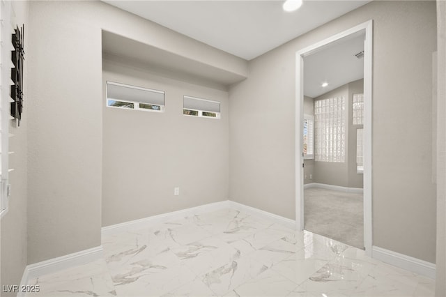 laundry room with marble finish floor and baseboards