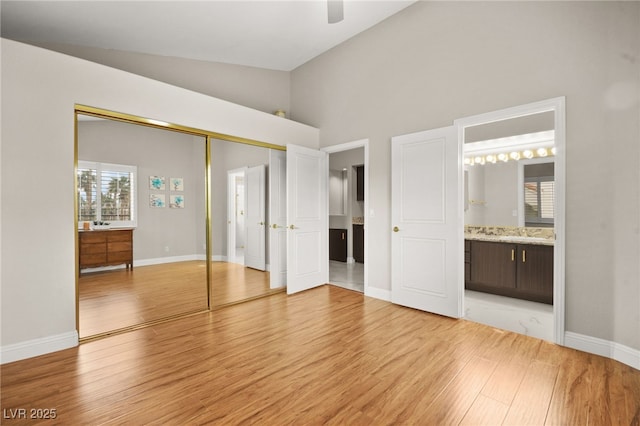 unfurnished bedroom with baseboards, light wood-type flooring, and a closet