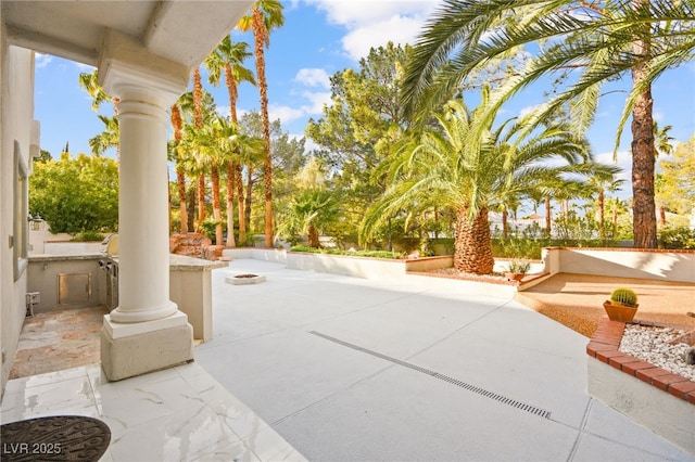 view of patio with an outdoor fire pit