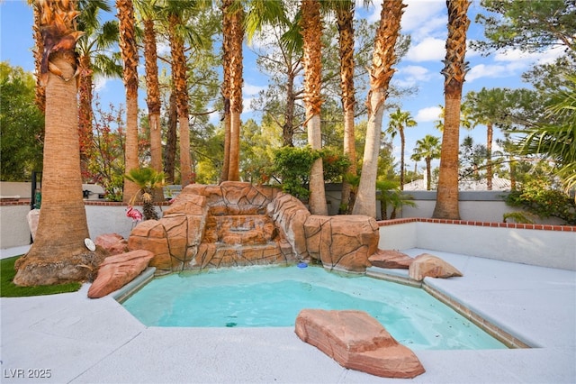 view of swimming pool featuring an in ground hot tub